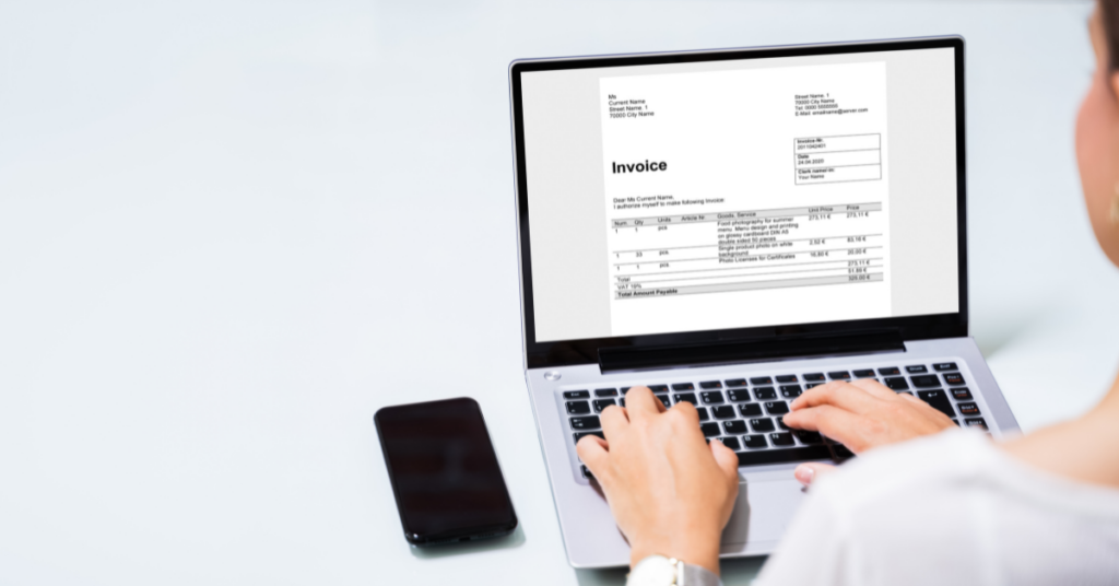 invoice on laptop screen with woman typing