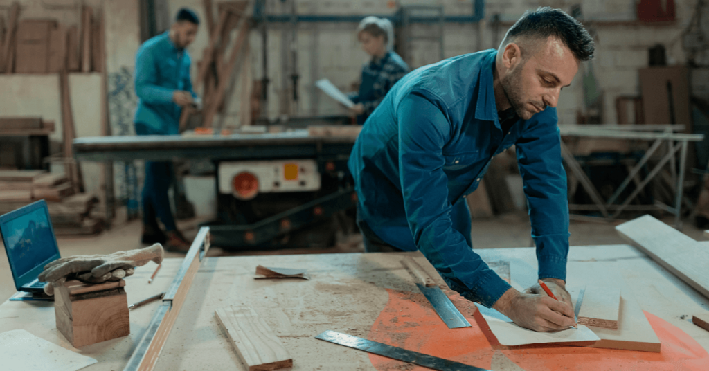 Man working at work bench with tools.