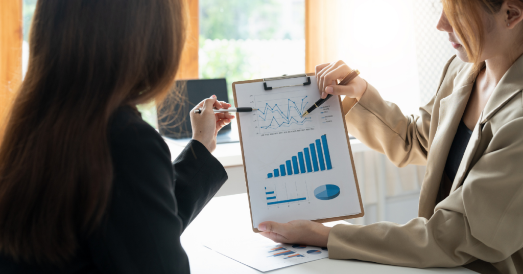 Two women looking at graph or chart