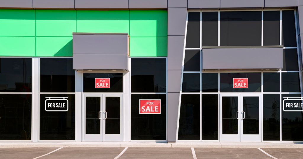 business store front with for sale signs in windows.