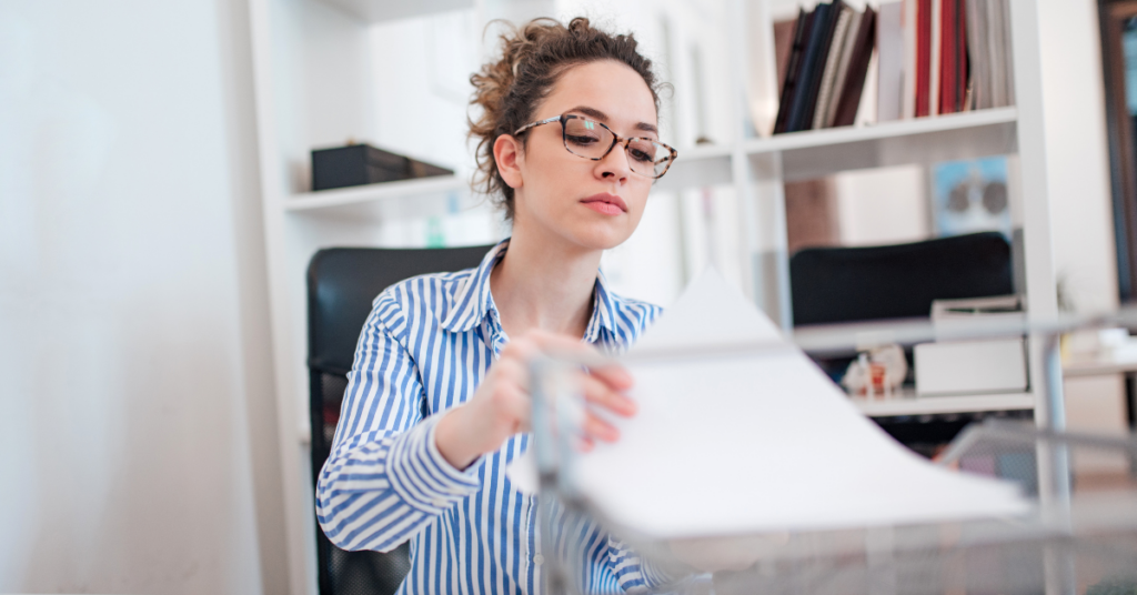 Female admin assistant looking at paperwork.